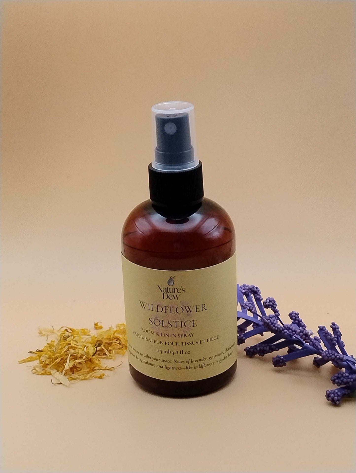 Wildflower Solstice Room & Linen Spray bottle with lavender and dried petals, seasonal summer release.