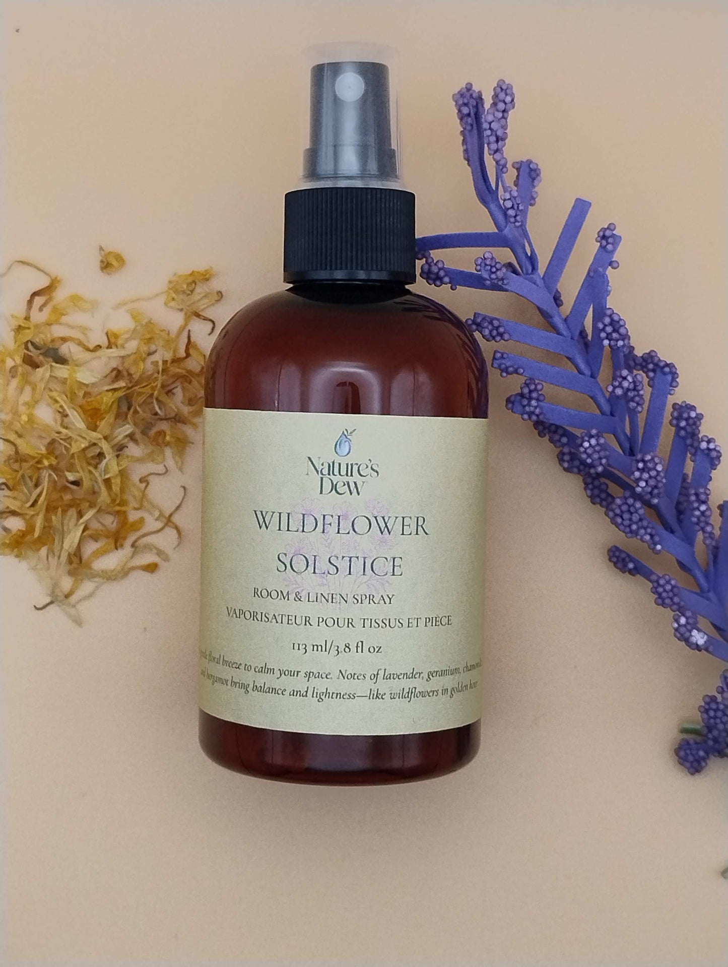 Wildflower Solstice Room & Linen Spray bottle with purple flowers and yellow petals, 113 mL, limited summer release.