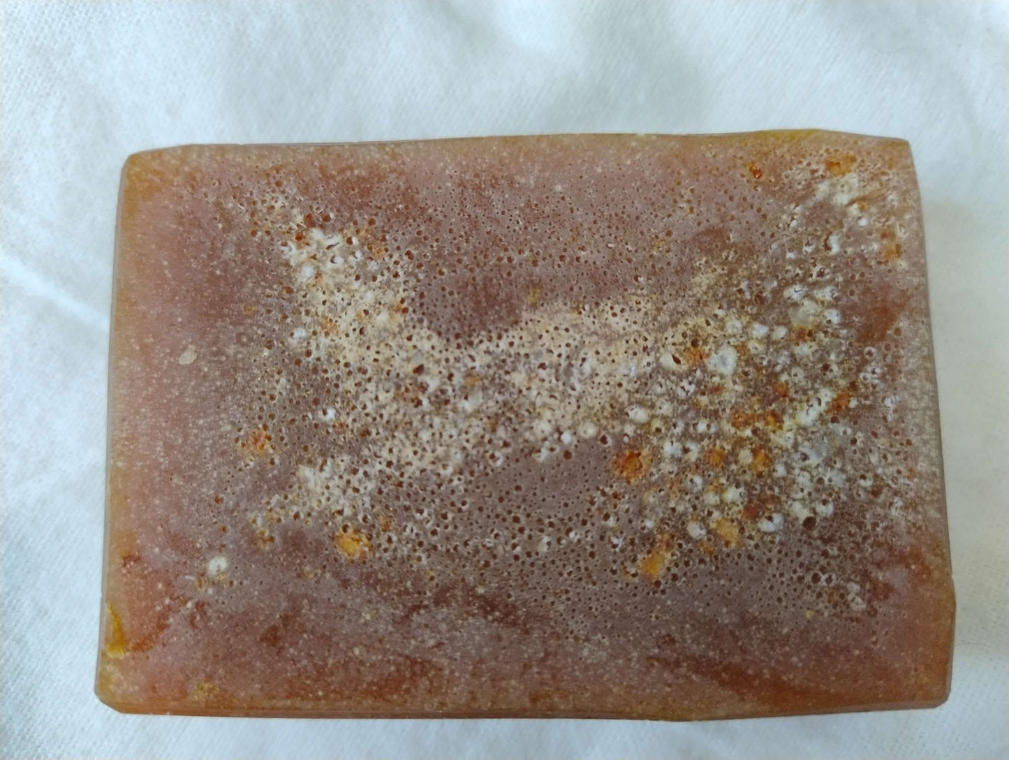 Autumn Ember Ritual Soap bar with warm, earthy tones and natural speckles, evoking cozy autumn scents of spice, citrus, and woody notes.