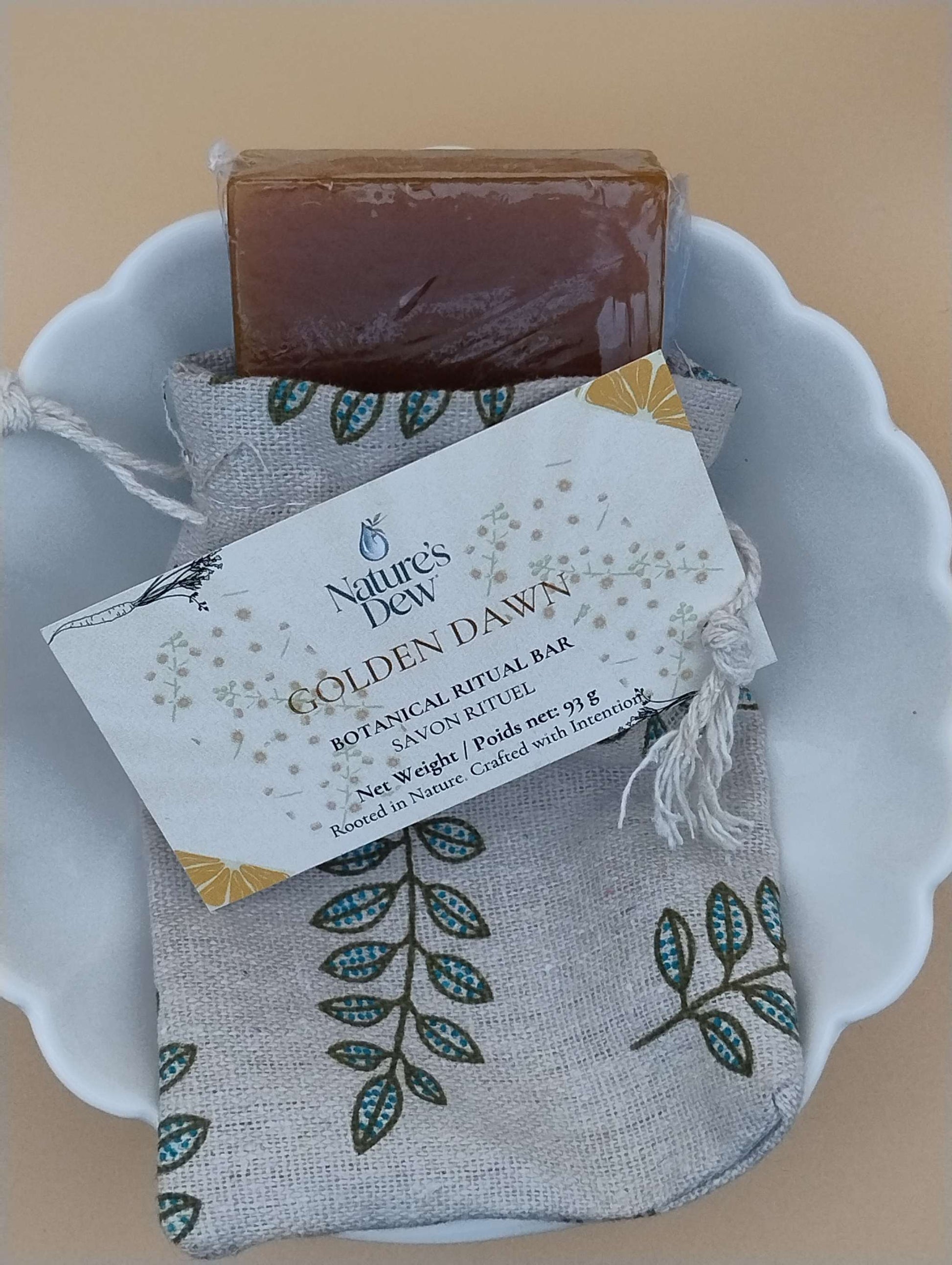 Golden Dawn Ritual Soap Bar in dish with floral packaging.
