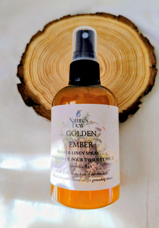 Golden Ember Linen & Room Spray bottle with earthy cedarwood and vetiver scent on wooden background